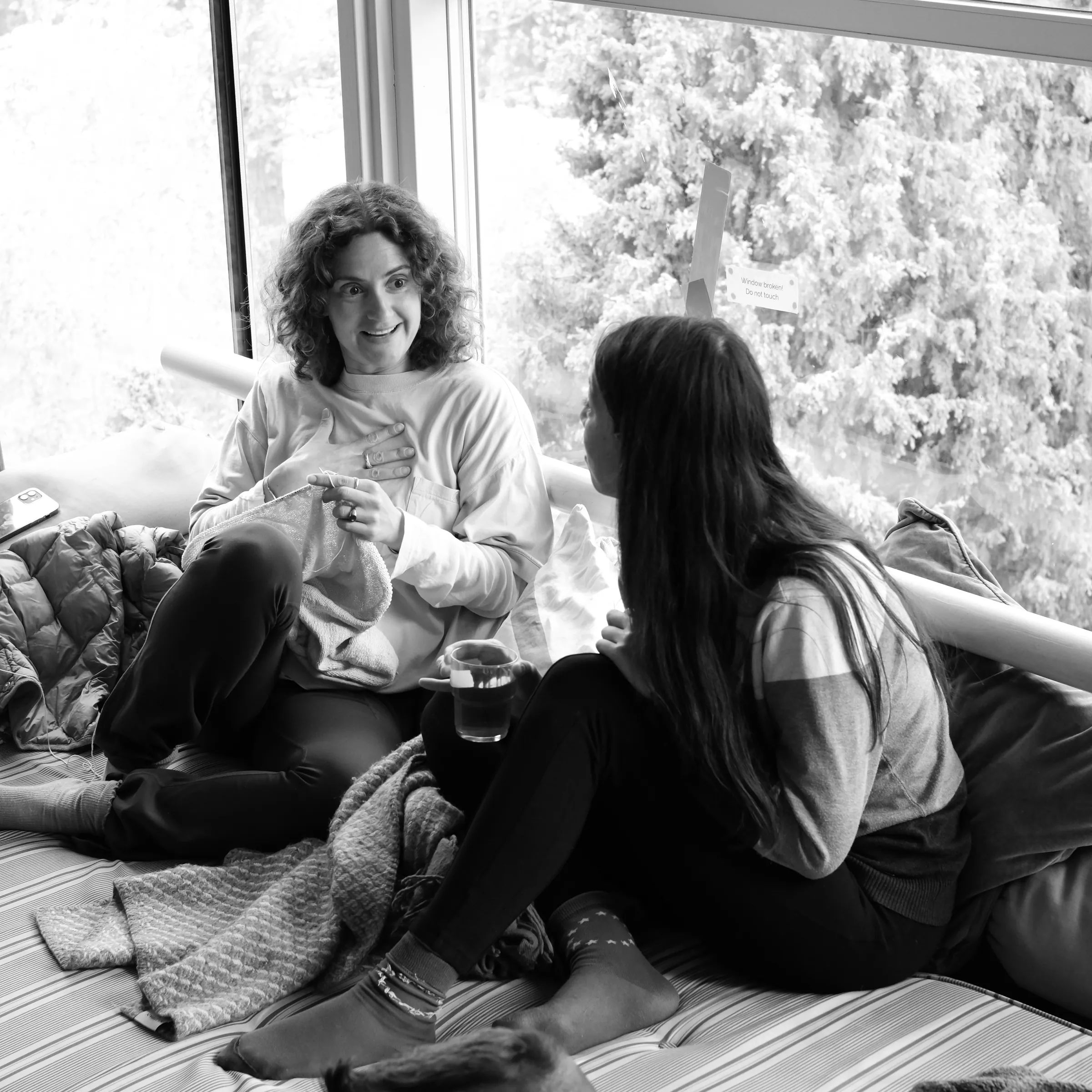 Two people in conversation by a window at Lakefront.