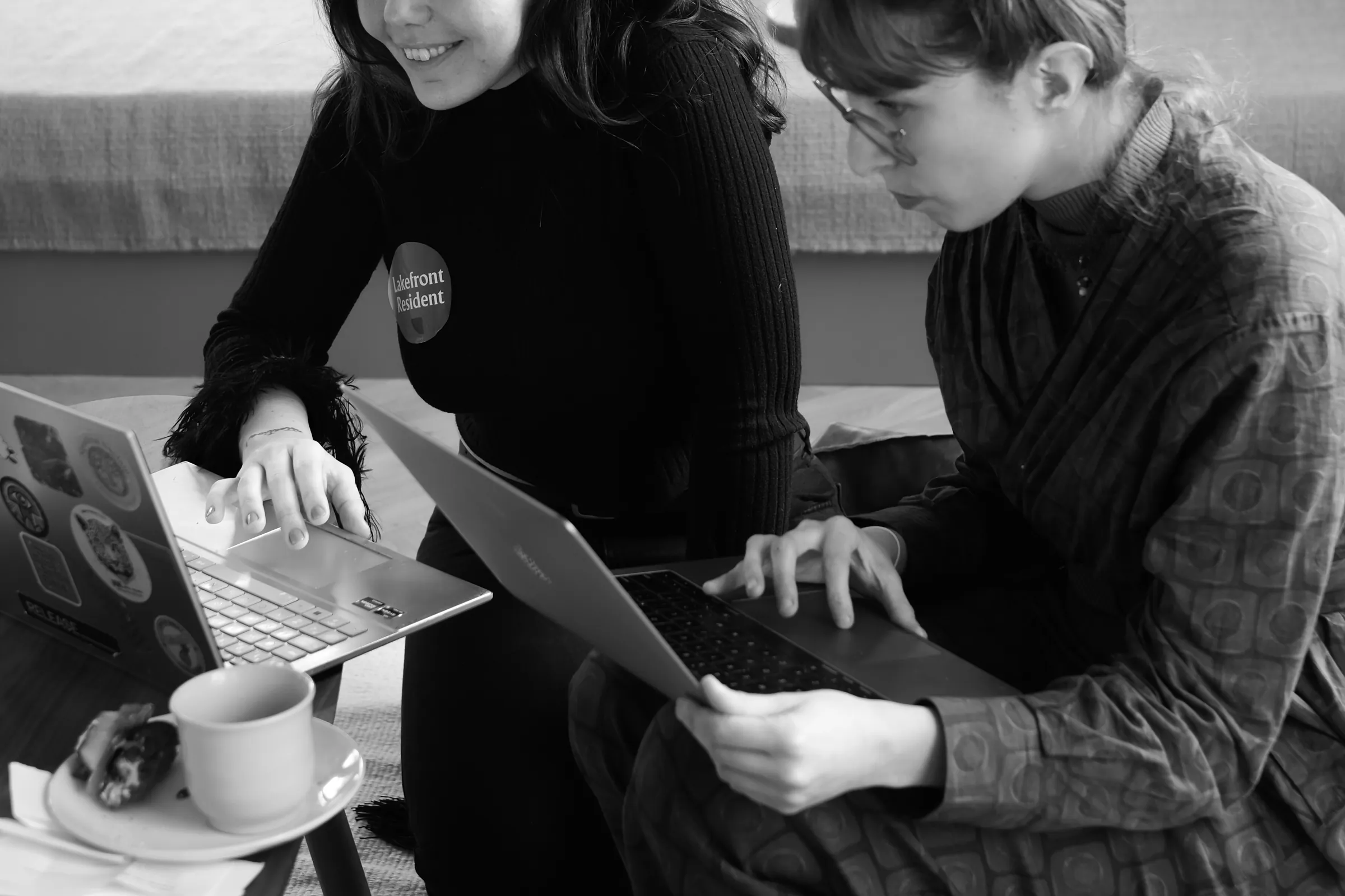 Two people working together on laptops at Lakefront.