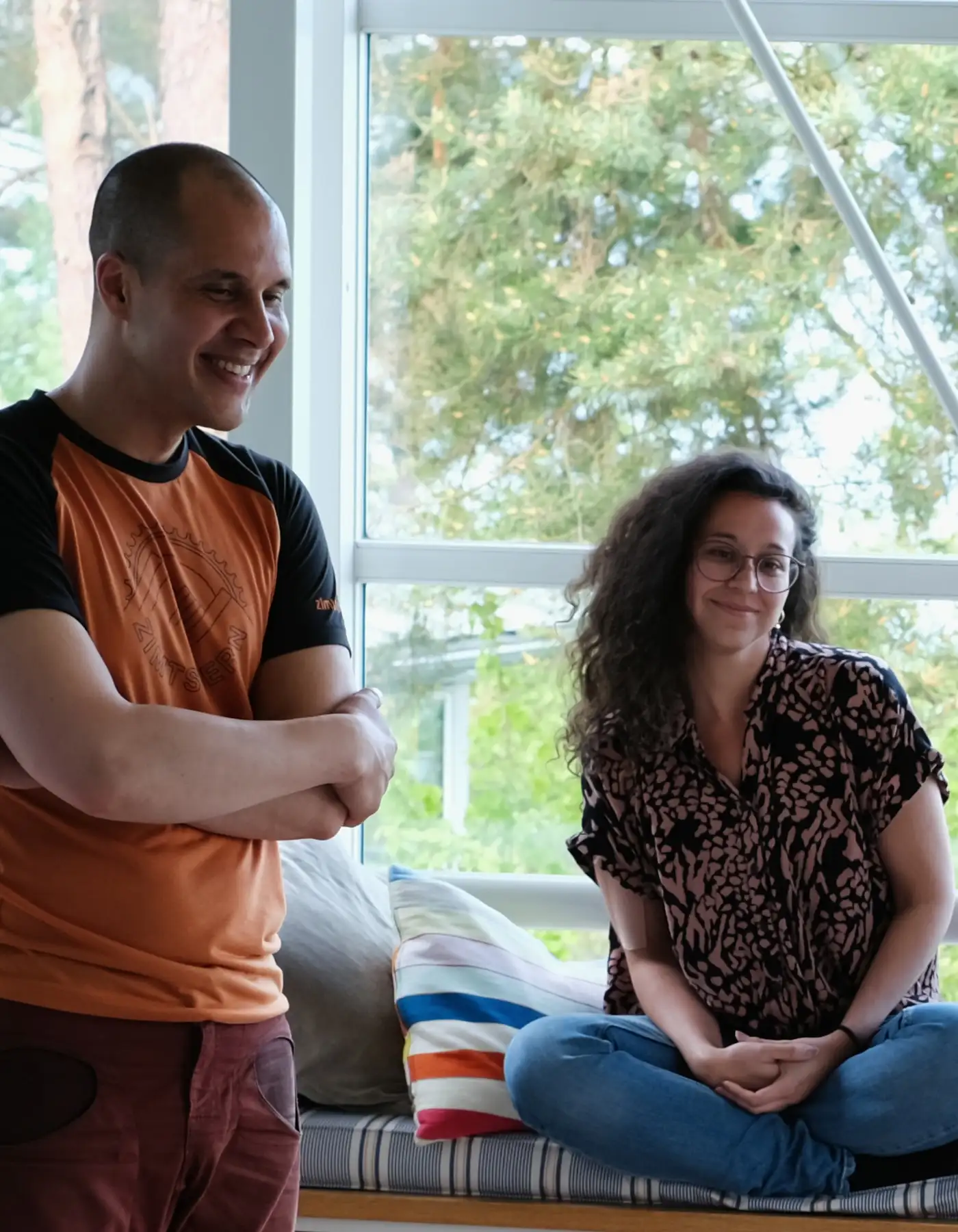 Two Lakefront residents talking in a shared living space.