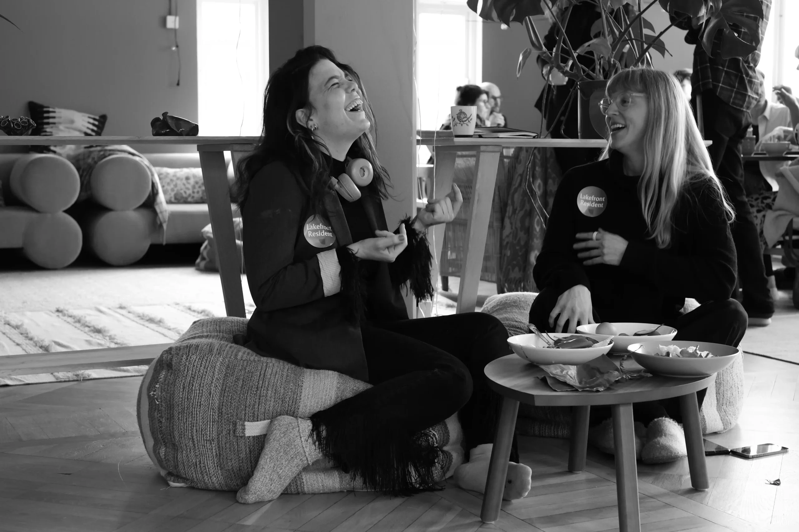 Two Lakefront residents laughing together during a gathering.